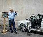 Taxi Driver with a Sign